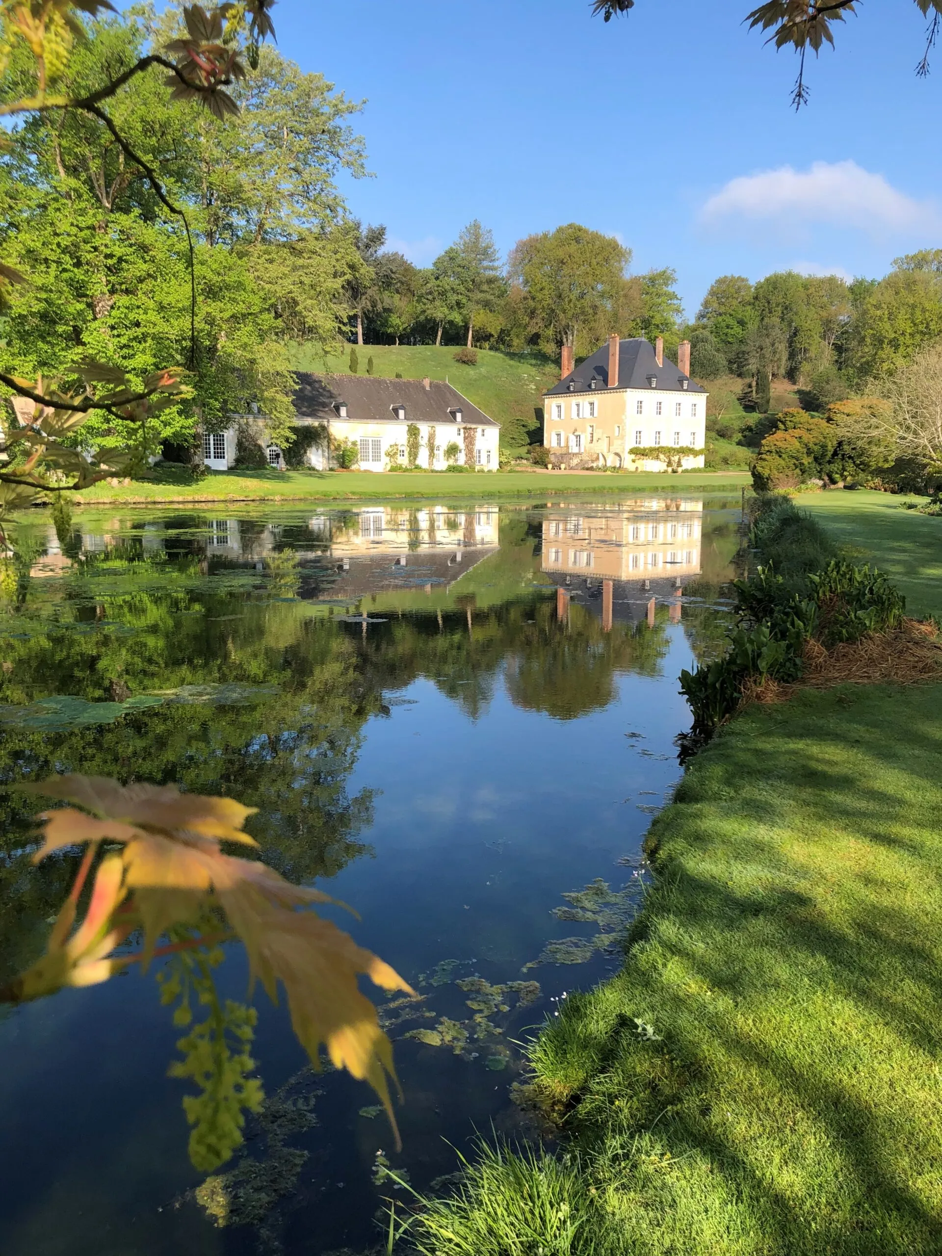 3 parcs et jardins à découvrir au printemps ! 1 Vue sur la maison se reflétant sur l'étang